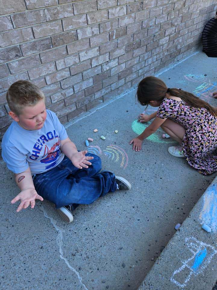 Kids playing with chalk at a licensed full-time childcare center in Filer, ID