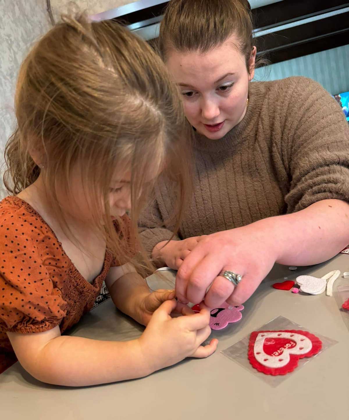 Teacher guiding a child during early learning activities at a childcare center