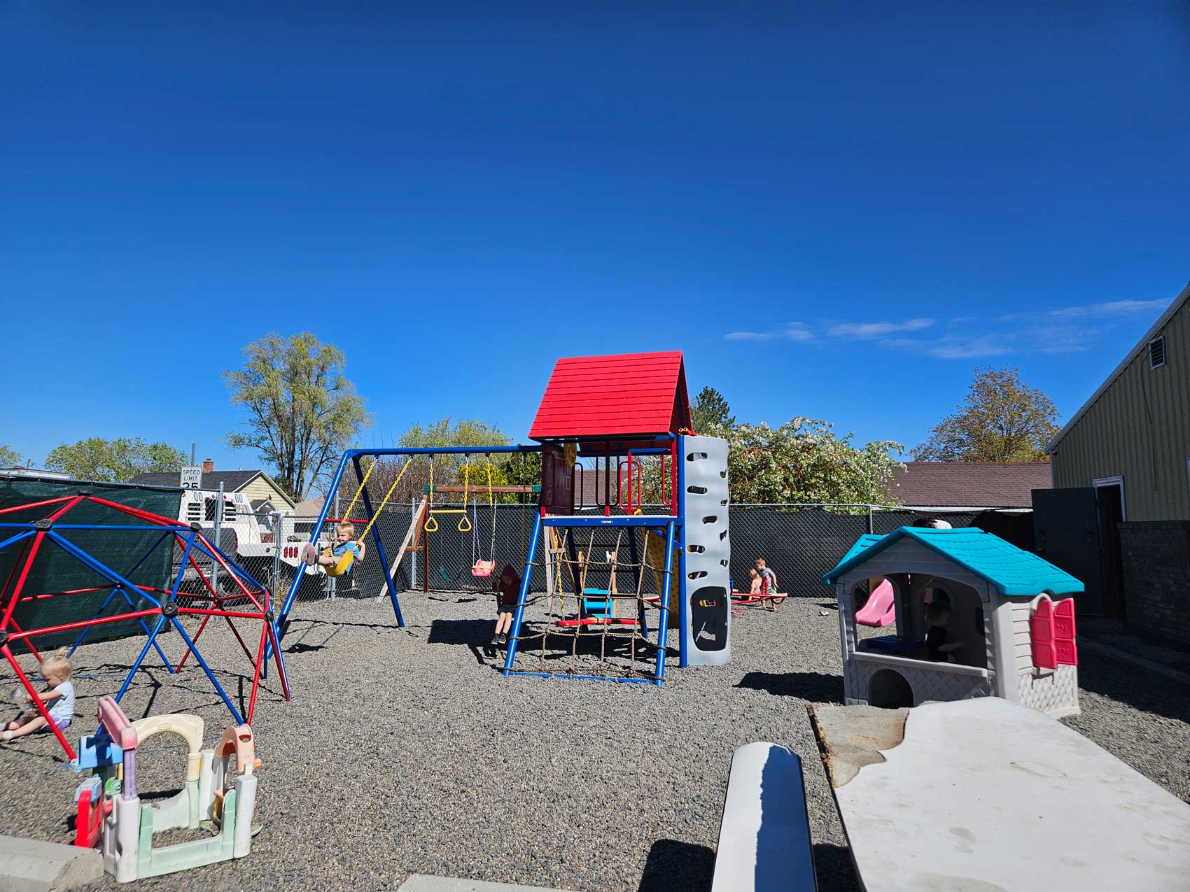 Children enjoying a playground at a licensed daycare center in Twin Falls, ID